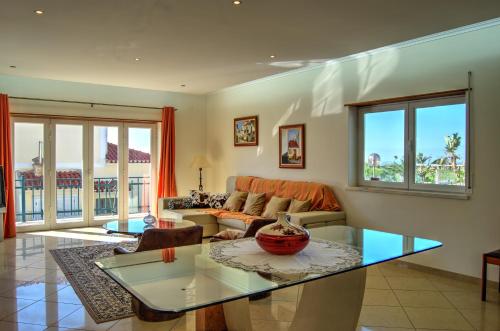a living room with a couch and a table at Rancho Mar à Vista in Atalaia de Cima
