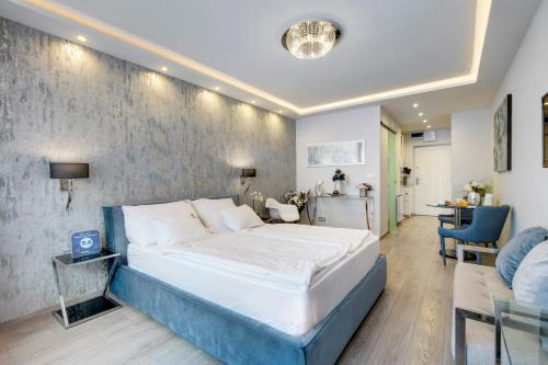 a bedroom with a large bed and a living room at Danube Corso Boutique Apartment in Budapest