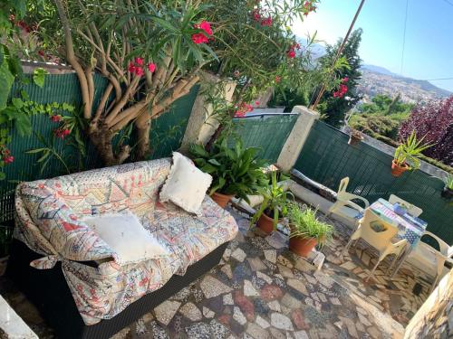 a couch sitting on a patio with potted plants at Casa al-andalus in Granada