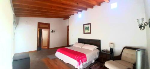 1 dormitorio con cama y sofá en Finca Catalina Hotel Boutique en Tepoztlán