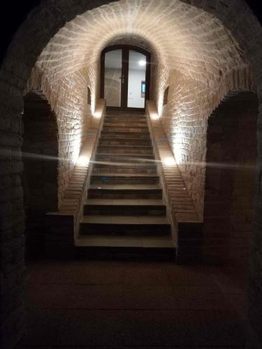 a staircase in a brick building with stairs leading to a door at Apartmán Starovičky 406 in Starovičky