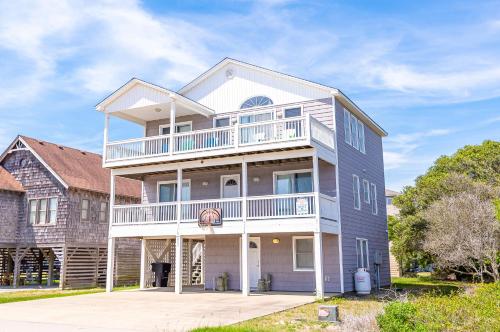 a large house with a balcony on top of it at Ocean View's in Kill Devil Hills