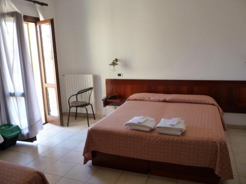 Кровать или кровати в номере Hotel L'Ancora