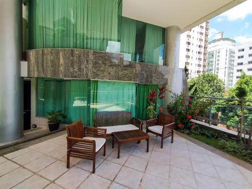 a patio with chairs and a table on a building at Savassi Village in Belo Horizonte