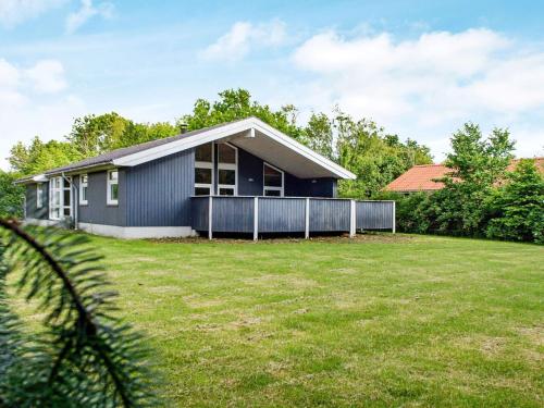 a house with a large yard in front of it at 7 person holiday home in Hemmet in Falen