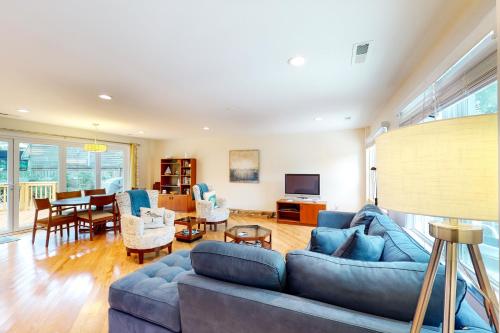 a living room with a blue couch and a dining room at 29th Avenue 20 in Isle of Palms