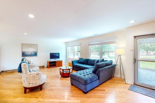 a living room with a blue couch and two chairs at 29th Avenue 20 in Isle of Palms