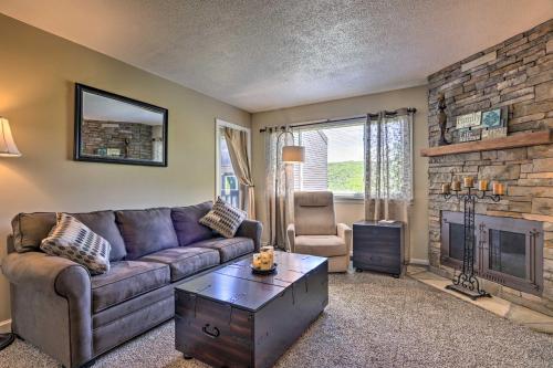 a living room with a couch and a fireplace at Condo with Pool and Grill Access about 4 Mi to Gatlinburg! in Gatlinburg