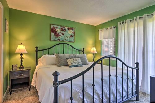 a bedroom with green walls and a bed and a window at Condo with Pool and Grill Access about 4 Mi to Gatlinburg! in Gatlinburg
