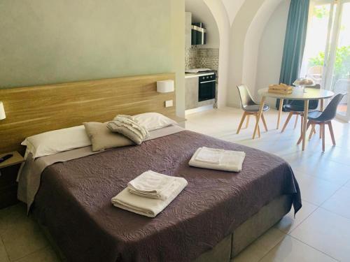 a bedroom with a bed and a table with chairs at VILLA LUCIA in Castellammare di Stabia