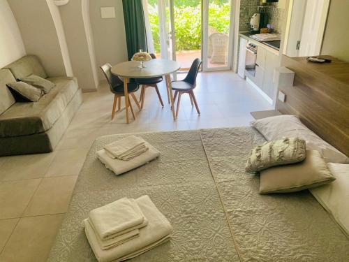 a living room with a couch and a table with chairs at VILLA LUCIA in Castellammare di Stabia