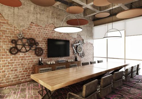 a conference room with a table and a tv on a brick wall at Novotel Mexico City Toreo in Mexico City
