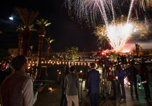 a group of people standing around watching fireworks at Fairmont Royal Palm Marrakech in Marrakech