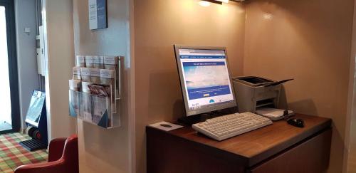 a computer monitor and keyboard on a desk at Best Western Hotel Apollo in Oulu