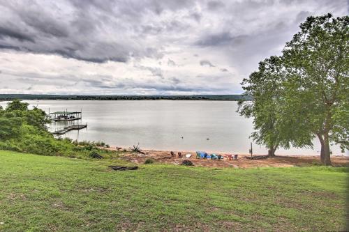a view of a lake with a dock on the shore at Lakefront Home with Private Beach Access! in Eufaula