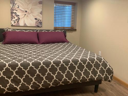 a bedroom with a black and white comforter on a bed at Dillon Ave Homes in Cheyenne