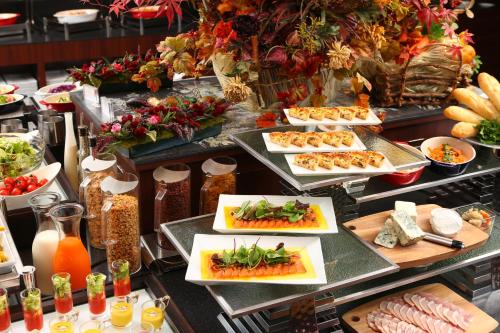 a buffet with many plates of food on a table at Quintessa Hotel Osaka Bay in Osaka