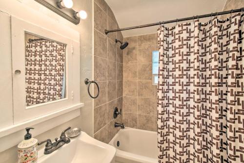 a bathroom with a sink and a shower curtain at Cozy Unit with Patio Walk to Dining, Lake Elkhart! in Elkhart Lake