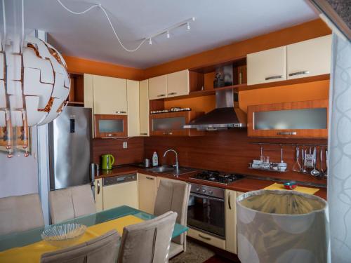 a kitchen with white cabinets and a table with chairs at Villa Volga in Jelsa