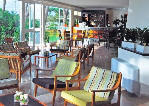 a restaurant with a bunch of chairs and a bar at Torre Del Sole in Terracina