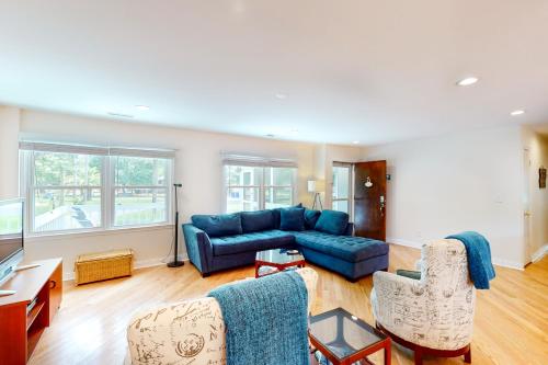 a living room with a blue couch and chairs at 29th Avenue 20 in Isle of Palms