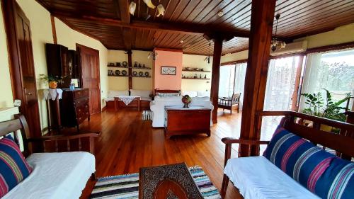 a living room with wooden floors and couches at Varosi Guesthouse in Edessa