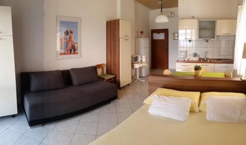 a living room with a couch and a kitchen at Studio ground floor with terace in Brela