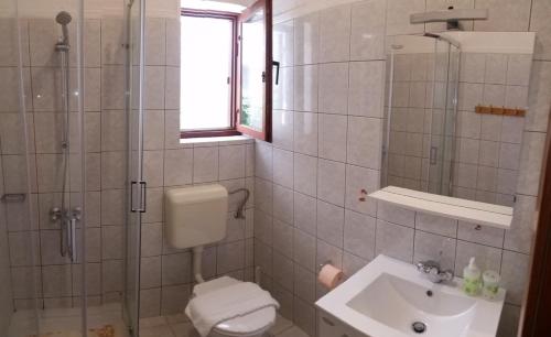 a bathroom with a sink and a toilet and a shower at Studio ground floor with terace in Brela
