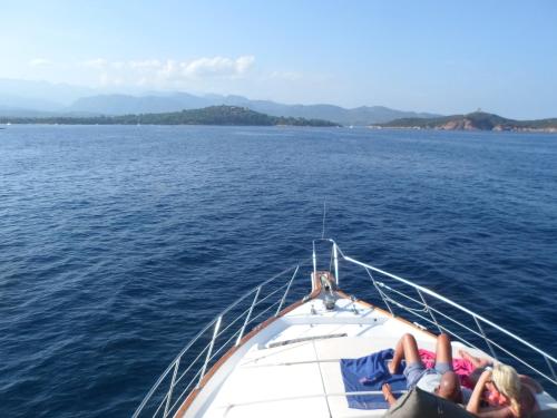 two people laying on the back of a boat in the water at Ocean Yacht Trawler - Le Caloa in Porto-Vecchio