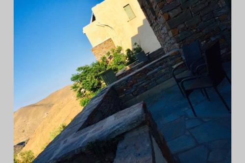 a building with two chairs sitting on top of a hill at starryhouse in Fotimárion