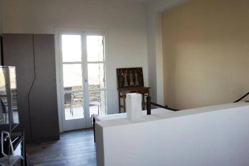 a living room with a large window and a door at starryhouse in Fotimárion