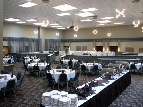 a banquet hall filled with tables and chairs with white plates at Holiday Inn Portland- I-5 S Wilsonville by IHG in Wilsonville