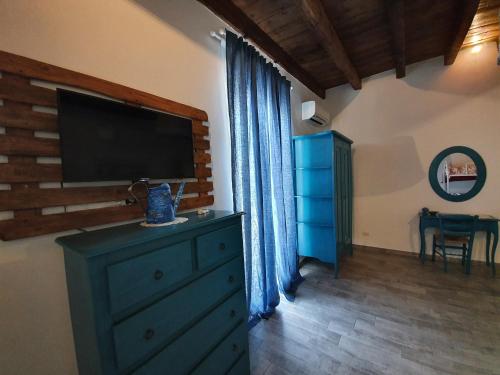 a room with a dresser with a flat screen tv on the wall at B&B La Terrazza di NonnAnna in Taranto