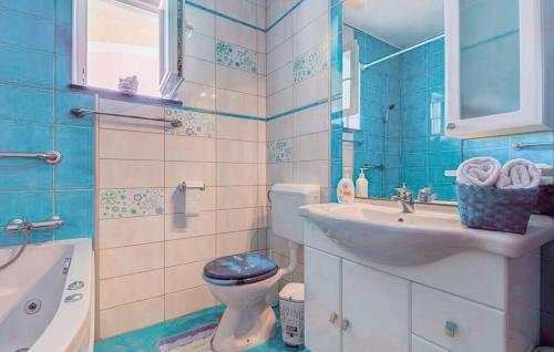 a blue and white bathroom with a toilet and a sink at Villa Sweet Home in Vodnjan