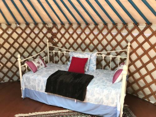 a bed in a yurt with pillows on it at French Fields Luxury Glamping Twin Emperor Tent in Le-Vieux-Cérier