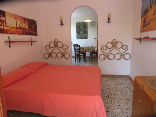 En eller flere senge i et værelse på I GECHI - MARINA DI CAMPO