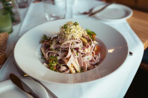 a white bowl of food on a table at Hotel Feyrer in Senden