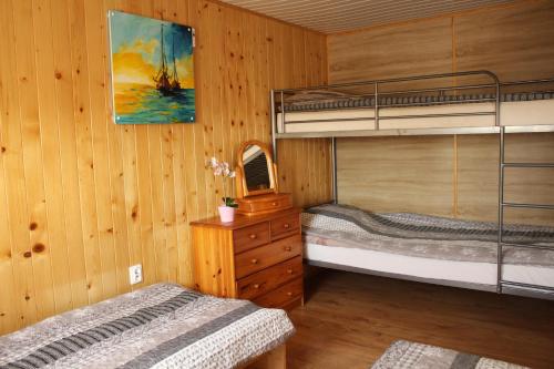 two bunk beds in a room with wooden walls at Ranczo u Ani in Ustka
