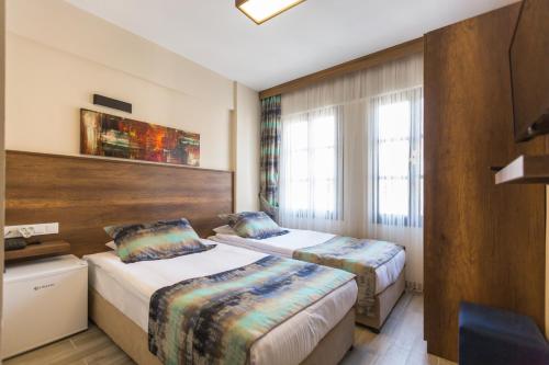 Giường trong phòng chung tại OLD TOWN BOUTIQUE HOTEL