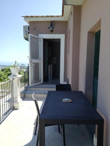 a table and chairs on the balcony of a house at Il Limoneto di Leo in Mascali