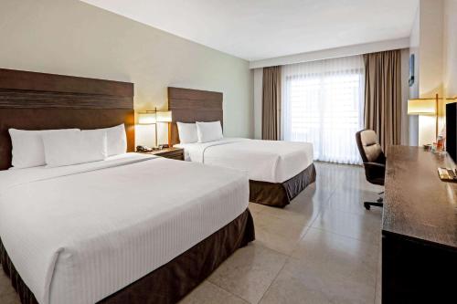 Ein Bett oder Betten in einem Zimmer der Unterkunft Wyndham Garden Cancun Downtown
