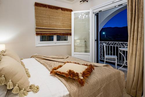 a bedroom with a bed and a large window at Aigli Villa in Zakynthos Town