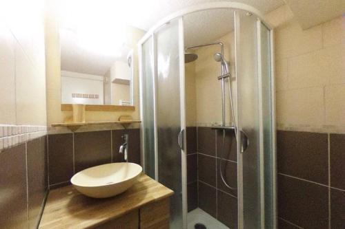 a bathroom with a shower with a toilet and a sink at Duplex Arc en Ciel - Les Deux Alpes in Mont-de-Lans