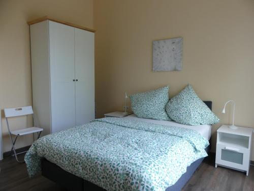 - une chambre avec un lit et une armoire blanche dans l'établissement Townhouse Kassel City Modern/Ruhig/Kostenlose Parkmöglichkeiten, à Cassel