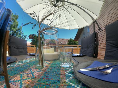 a table with an umbrella on top of a table at Ferienhaus Paradiso in Kirchheim unter Teck