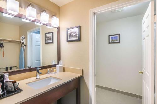 a bathroom with a sink and a mirror at Comfort Inn & Suites in Mojave