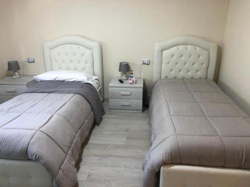 two beds sitting next to each other in a bedroom at Da nonna Antonietta in Ferrandina