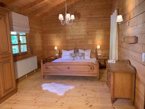 a bedroom with a bed in a wooden cabin at Chalet Zugspitze in Grainau