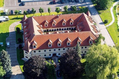 an overhead view of a large building with a red roof at Almtalhotel Appartements in Pettenbach in Pettenbach
