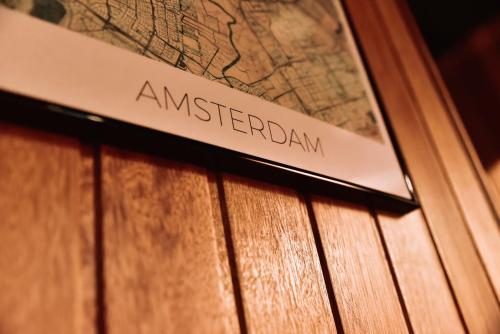 a sign that reads americanan on a wooden door at Durty Nelly's Inn in Amsterdam